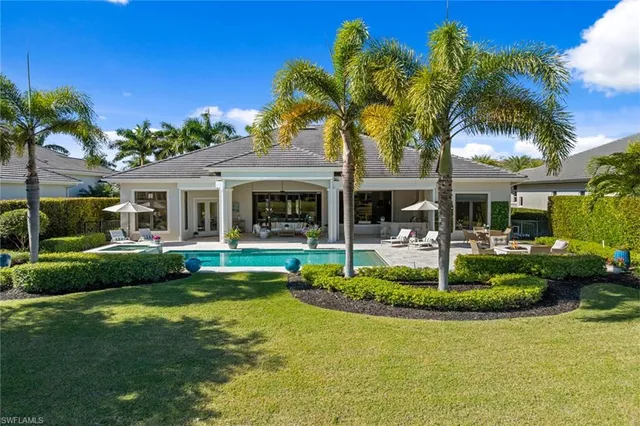 a front view of a house with a yard table and chairs