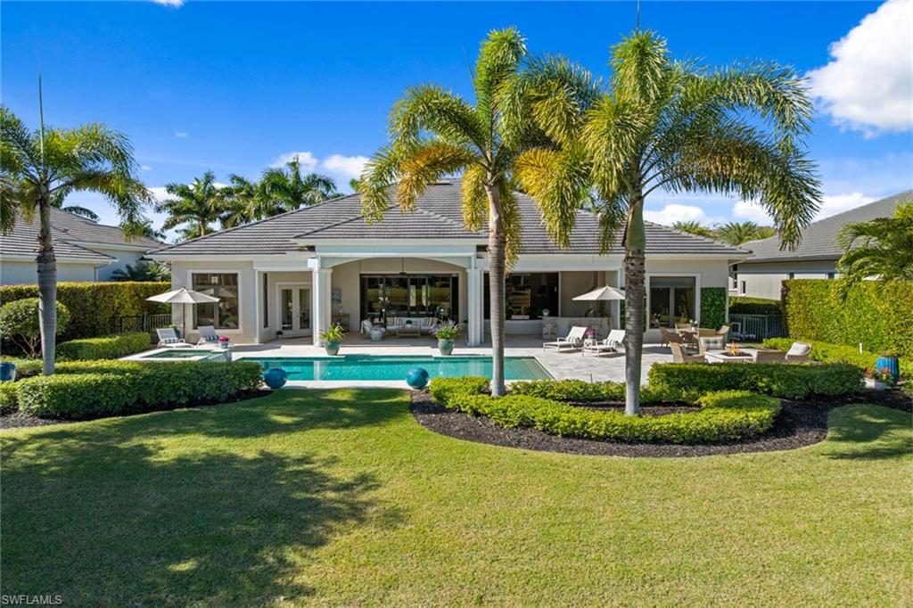4170 Cortland Way Naples, FL 34119 - Photo 37 of 41 Rear view of house with a patio area, french doors, a pool with connected hot tub, and stucco siding
