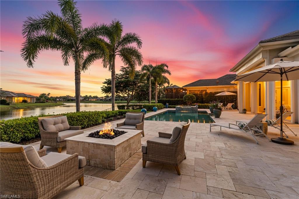 4170 Cortland Way Naples, FL 34119 - Photo 39 of 41 View of patio / terrace with a pool with connected hot tub, an outdoor living space with a fire pit, and a water view