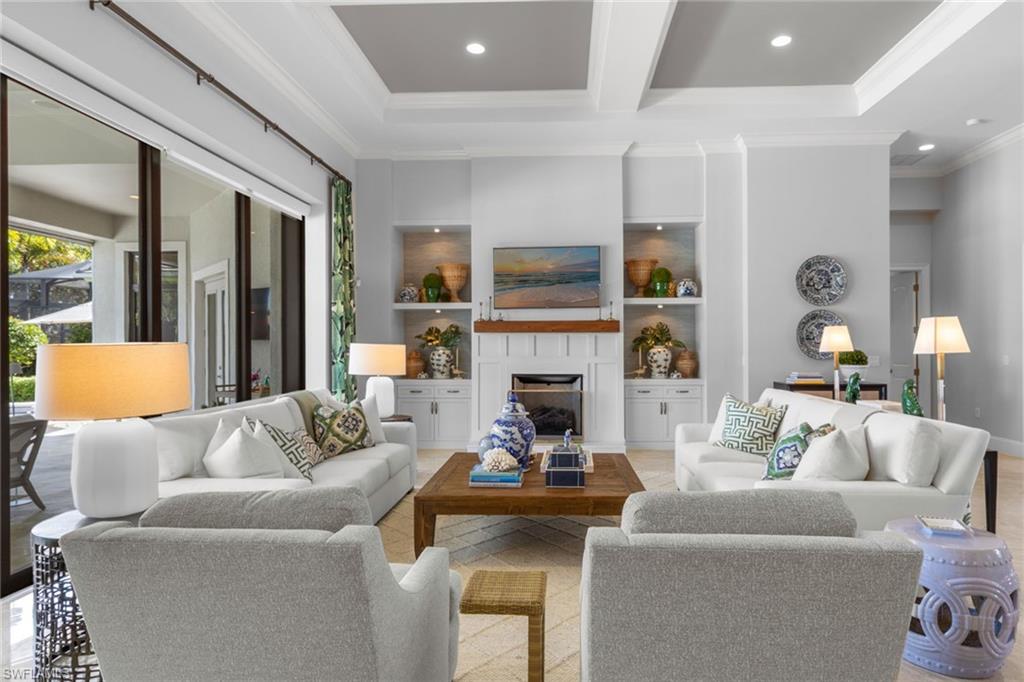 4170 Cortland Way Naples, FL 34119 - Photo 10 of 41 Living area featuring beamed ceiling, a fireplace, recessed lighting, and crown molding