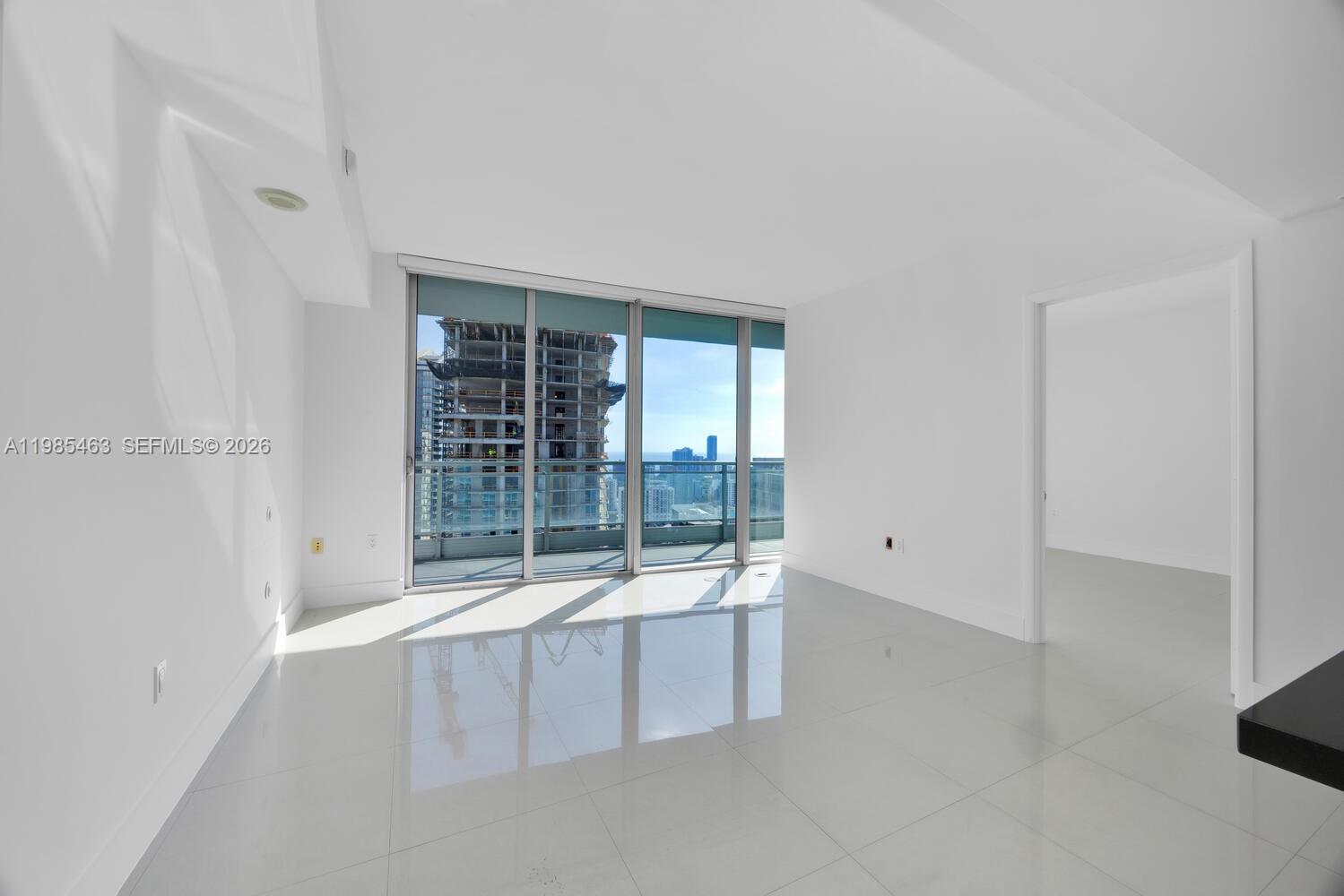 92 Southwest 3rd Street, Unit 3904 Miami, FL 33130 - Photo 2 of 30 an empty room with floor to ceiling window and an entrance