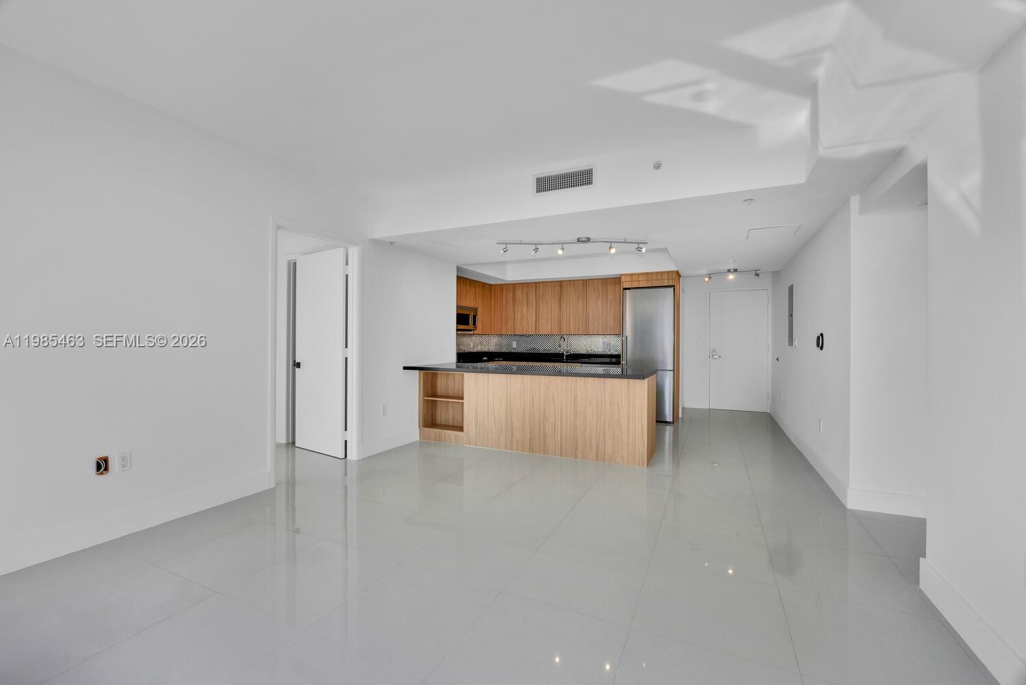 92 Southwest 3rd Street, Unit 3904 Miami, FL 33130 - Photo 4 of 30 a view of kitchen with refrigerator and white cabinets
