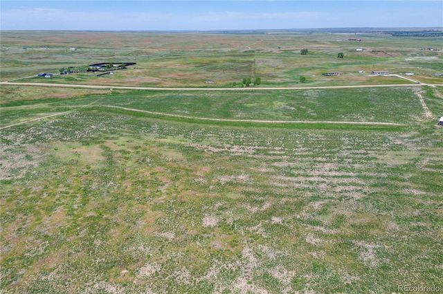 a view of a field with an ocean view