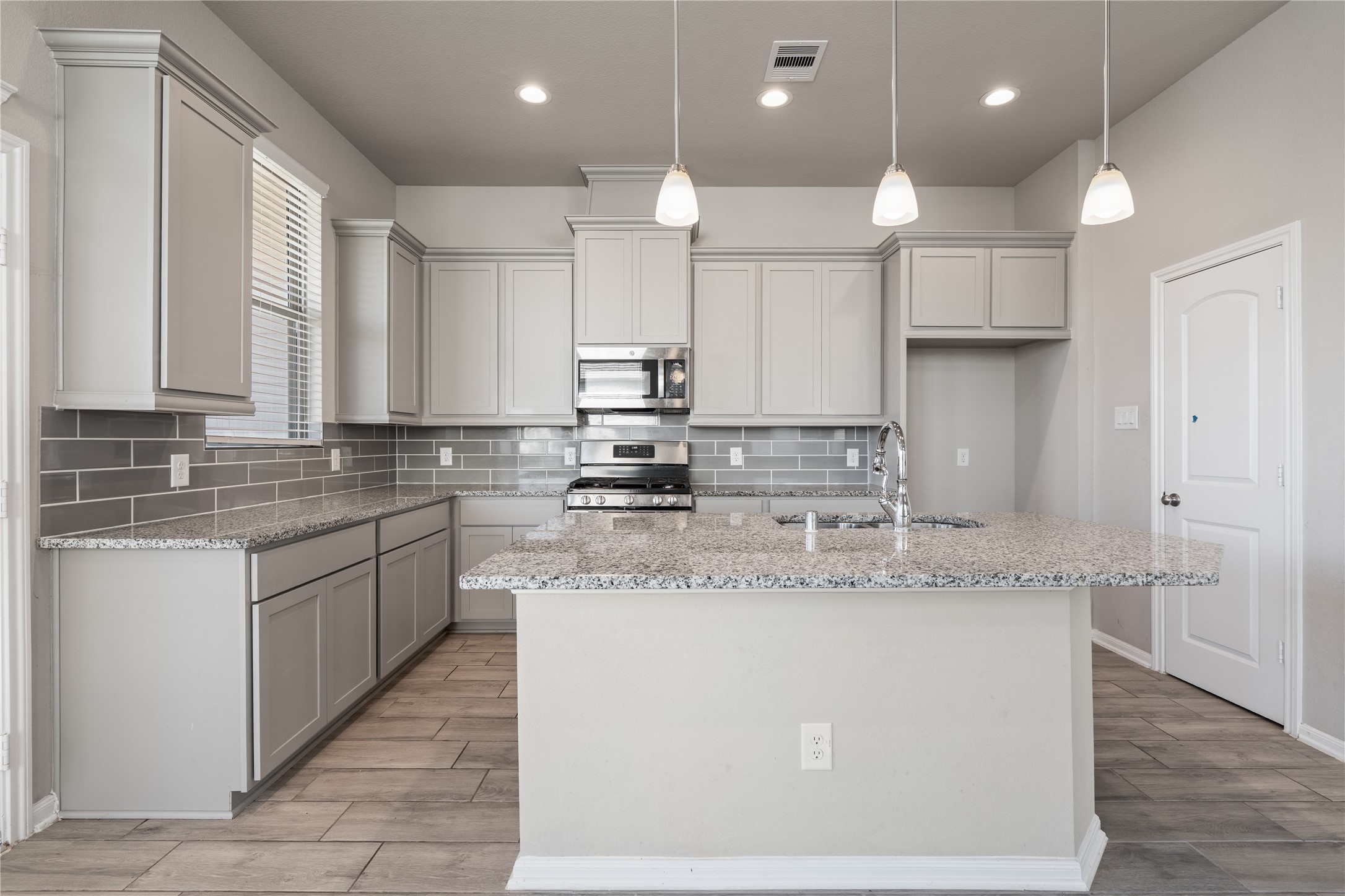 2522 Terrace Point Drive Missouri City, TX 77459 - Photo 9 of 25 a kitchen with kitchen island granite countertop a sink a counter space appliances and cabinets