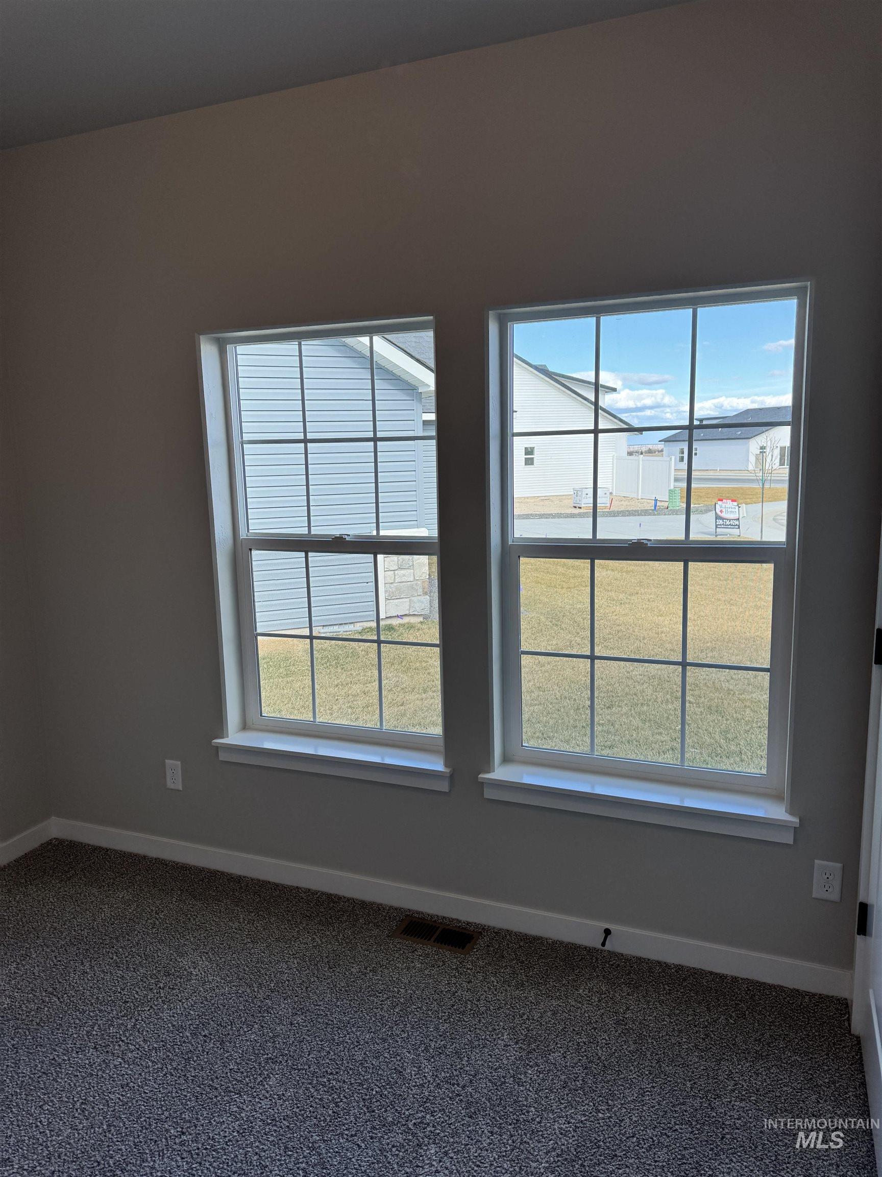 2064 Harrison Street South Twin Falls, ID 83301 - Photo 9 of 29 Spare room with healthy amount of natural light and dark carpet