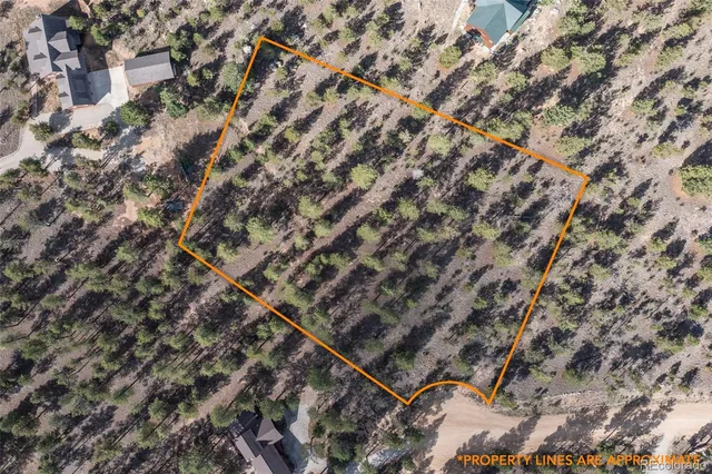 a view of a field with mountains in the background