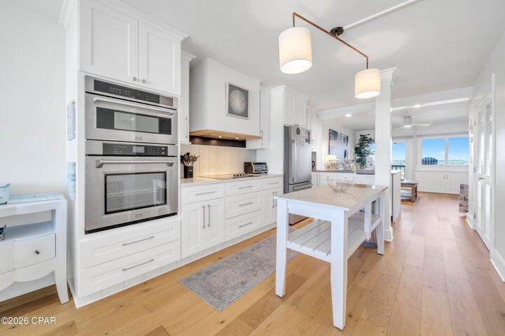 23223 Front Beach Road, Unit A1 PH10 Panama City Beach, FL 32413 - Photo 12 of 32 a kitchen with a stove a sink and a refrigerator