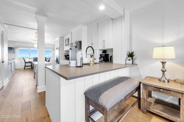 23223 Front Beach Road, Unit A1 PH10 Panama City Beach, FL 32413 - Photo 14 of 32 a kitchen with a sink a stove and cabinets