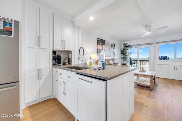 23223 Front Beach Road, Unit A1 PH10 Panama City Beach, FL 32413 - Photo 15 of 32 a kitchen with granite countertop a sink and cabinets