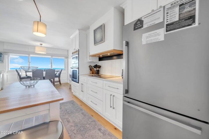 23223 Front Beach Road, Unit A1 PH10 Panama City Beach, FL 32413 - Photo 16 of 32 a kitchen with stainless steel appliances granite countertop a sink a stove and white cabinets