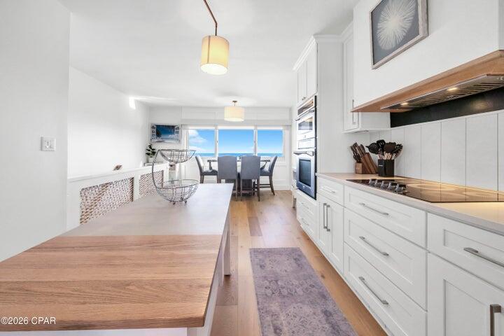 23223 Front Beach Road, Unit A1 PH10 Panama City Beach, FL 32413 - Photo 17 of 32 a view of a kitchen with kitchen island a large counter space a sink stainless steel appliances and cabinets
