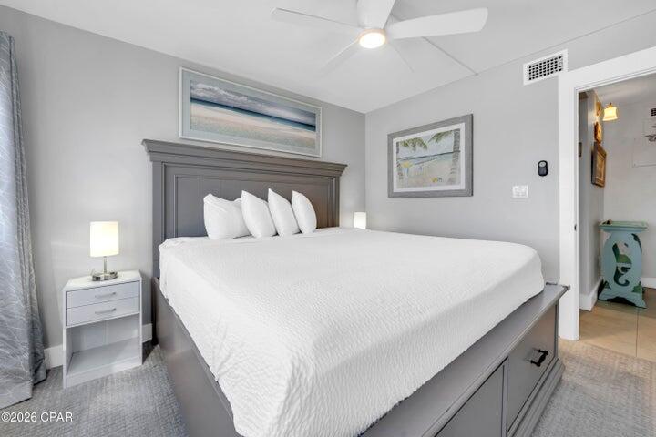 23223 Front Beach Road, Unit A1 PH10 Panama City Beach, FL 32413 - Photo 24 of 32 a bedroom with a bed and a night stand