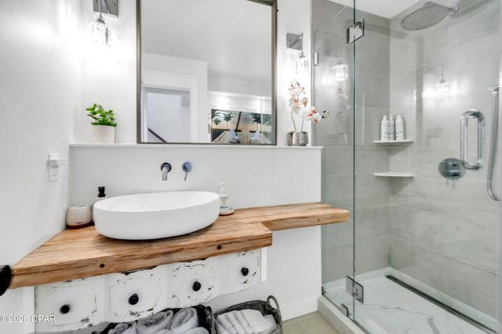23223 Front Beach Road, Unit A1 PH10 Panama City Beach, FL 32413 - Photo 25 of 32 a bathroom with a sink and a mirror