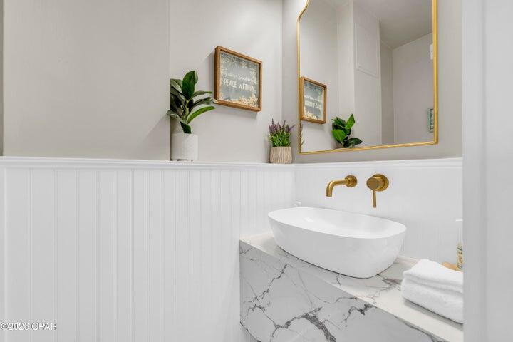 23223 Front Beach Road, Unit A1 PH10 Panama City Beach, FL 32413 - Photo 26 of 32 a bathroom with a sink and a mirror