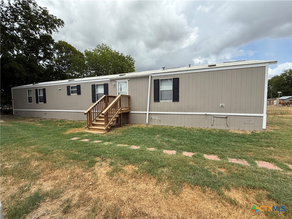 a view of house with backyard