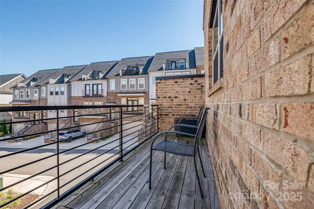 a view of a balcony with chairs and wooden floor