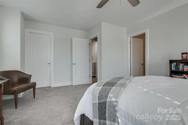 a bathroom with a granite countertop sink a toilet and mirror