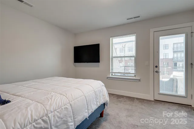 a bedroom with a large bed and a window