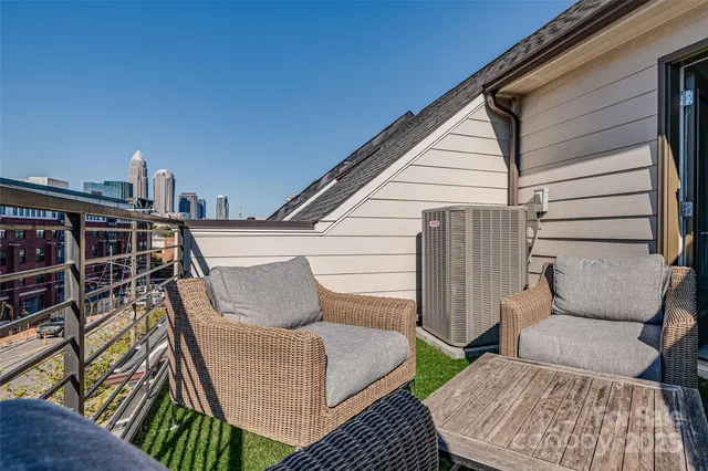 a living room with furniture and a book shelf
