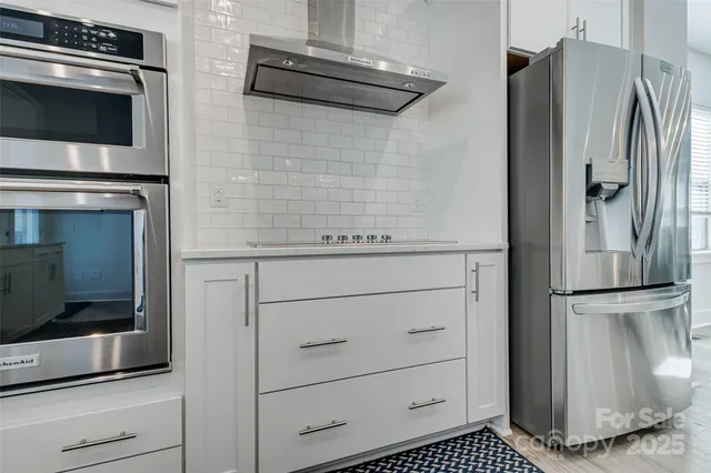 a kitchen with kitchen island a sink and wooden floor