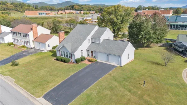 an aerial view of a house with outdoor space and lake view
