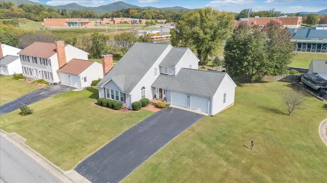 an aerial view of a house with outdoor space and lake view