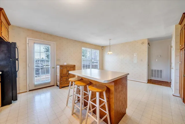 a view of a kitchen with furniture and wooden floor