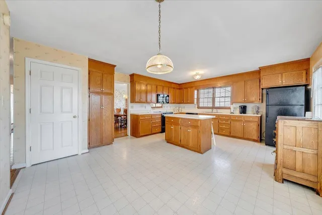a large kitchen with a lot of cabinets and stainless steel appliances