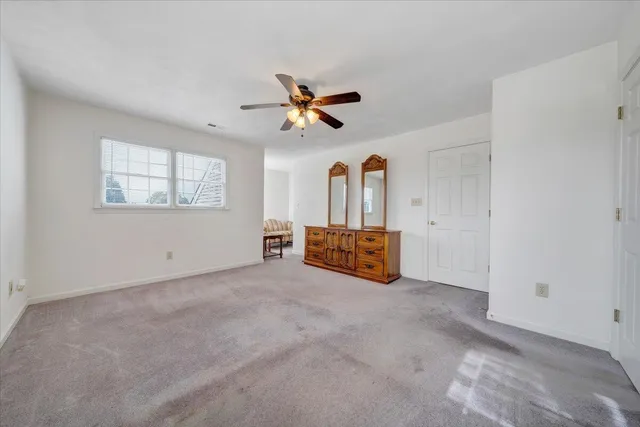 a living room with furniture and a ceiling fan