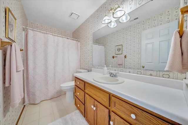 a bathroom with a sink a mirror and a shower curtain