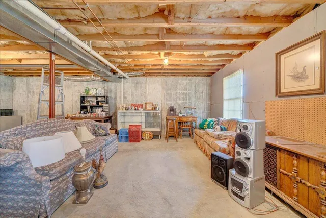 a view of a livingroom with furniture and a window