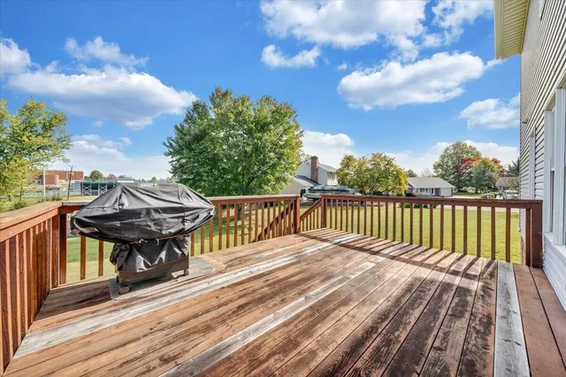 a view of balcony with wooden floor and fence