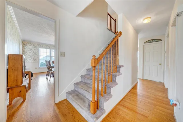 a view of entryway and hall with wooden floor