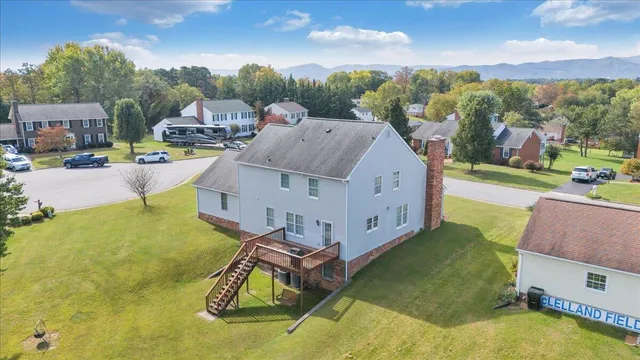 a view of a house with a swimming pool and a yard