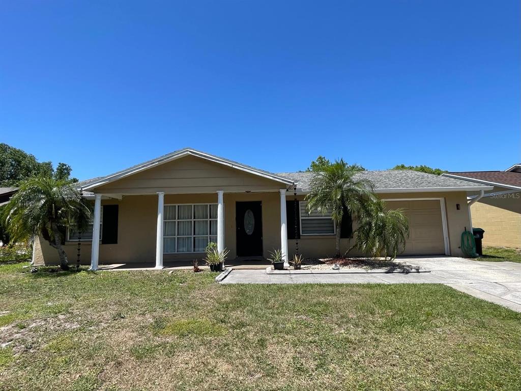 a view of a house with yard and tree s