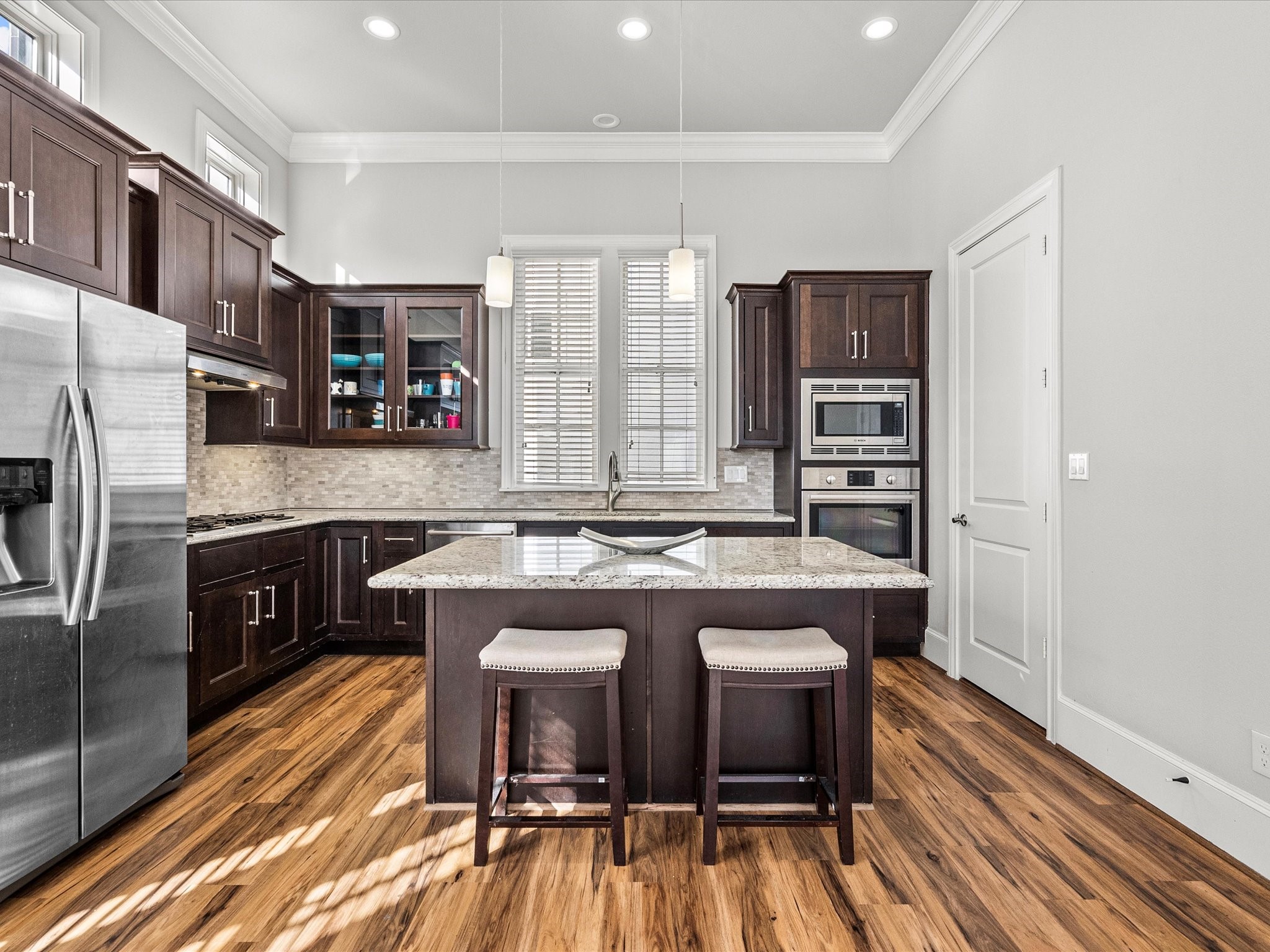 5616 Cohn Terrace Houston, TX 77007 - Photo 14 of 33 a kitchen with a refrigerator a stove a sink and dishwasher with wooden floor