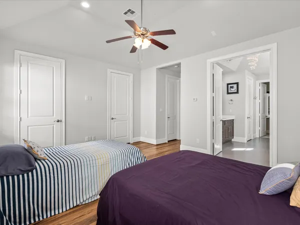 a bedroom with two beds and a chandelier