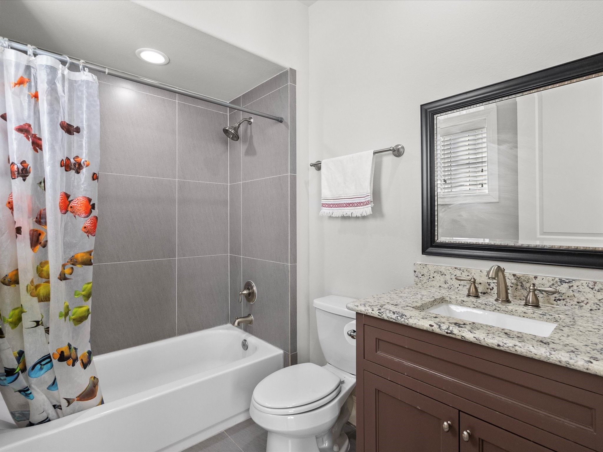 5616 Cohn Terrace Houston, TX 77007 - Photo 27 of 33 a bathroom with a granite countertop sink a toilet and shower