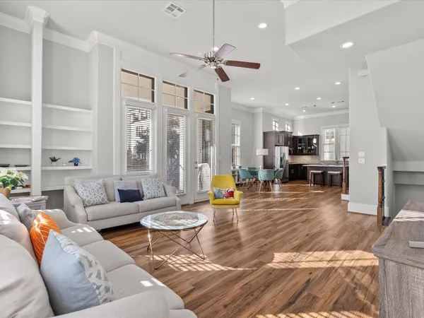 a living room with furniture wooden floor and a chandelier