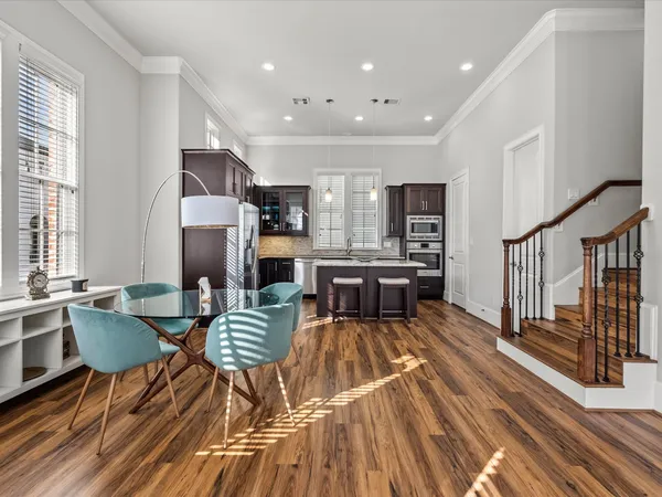 a living room with furniture a table and large windows