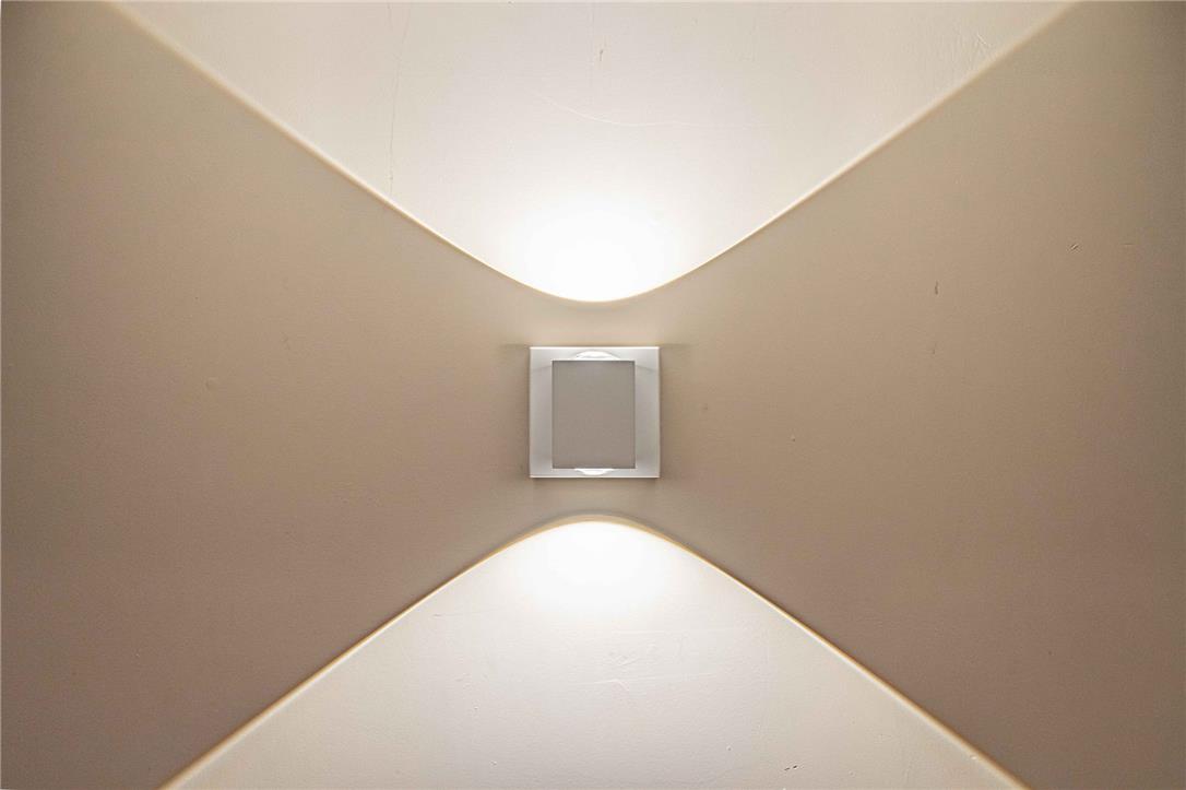102 Sutton Road Easton, PA 18045 - Photo 61 of 83 A modern wall sconce casts dramatic geometric light patterns across the smooth plaster surface.