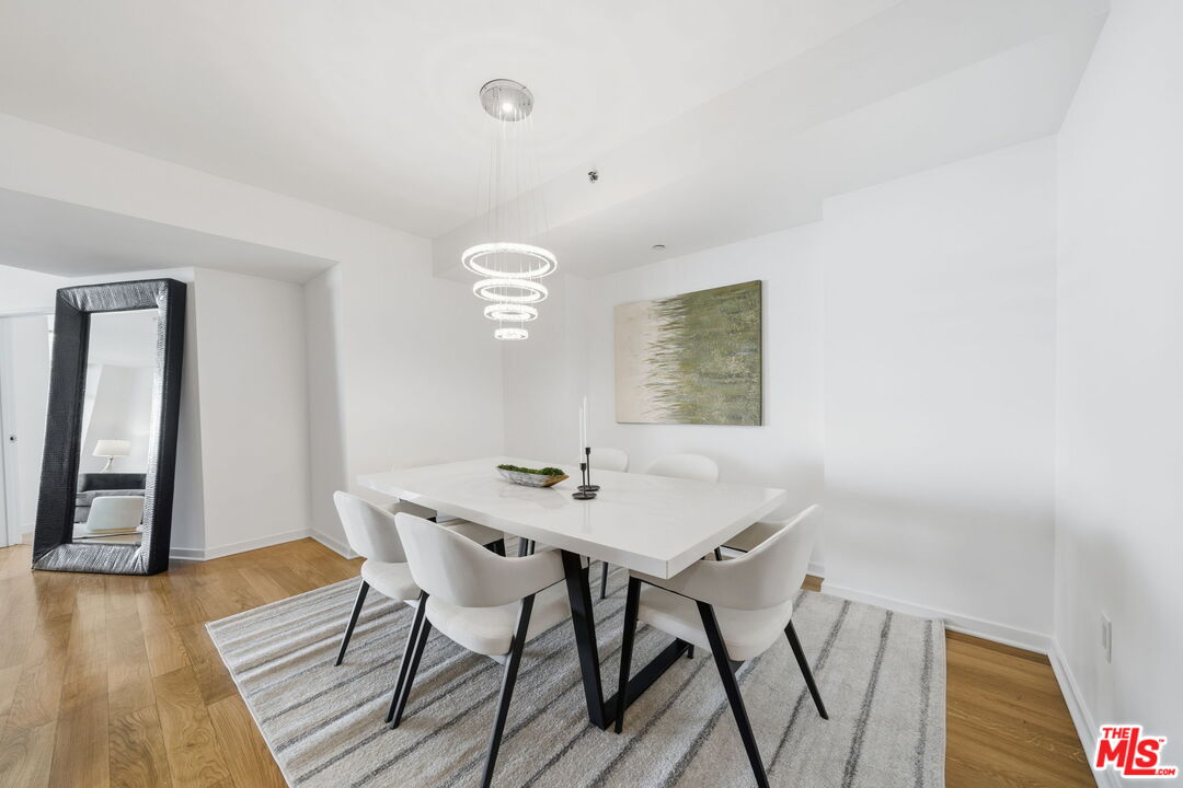 13650 Marina Pointe Drive, Unit 1603 Marina del Rey, CA 90292 - Photo 17 of 75 a view of a dining room with furniture and wooden floor