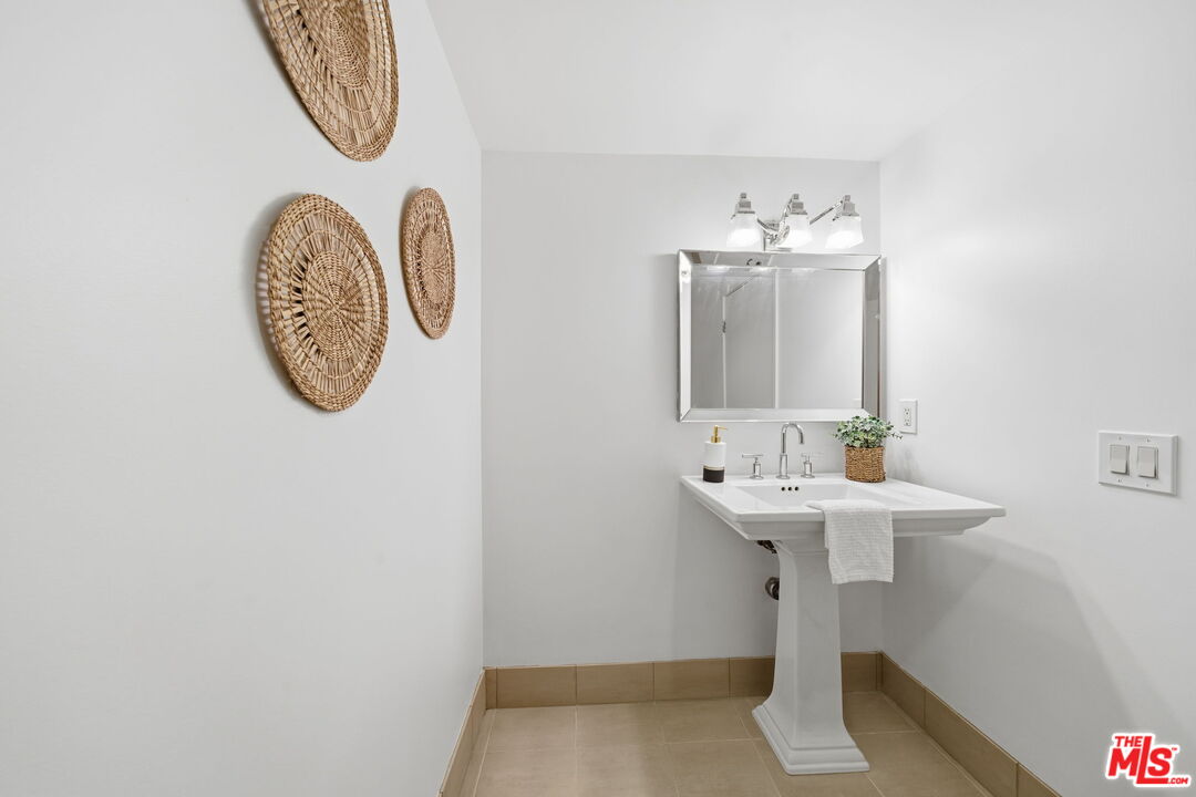 13650 Marina Pointe Drive, Unit 1603 Marina del Rey, CA 90292 - Photo 20 of 75 a bathroom with a sink and a mirror