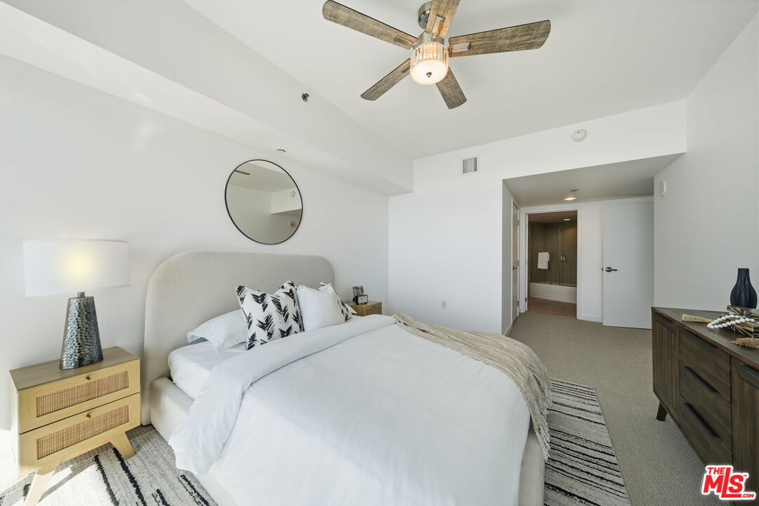13650 Marina Pointe Drive, Unit 1603 Marina del Rey, CA 90292 - Photo 21 of 75 a bedroom with a bed and a chandelier