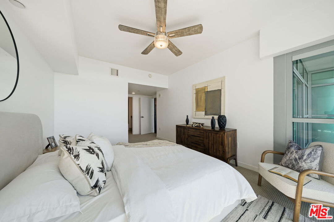 13650 Marina Pointe Drive, Unit 1603 Marina del Rey, CA 90292 - Photo 22 of 75 a bedroom with a bed and wooden floor