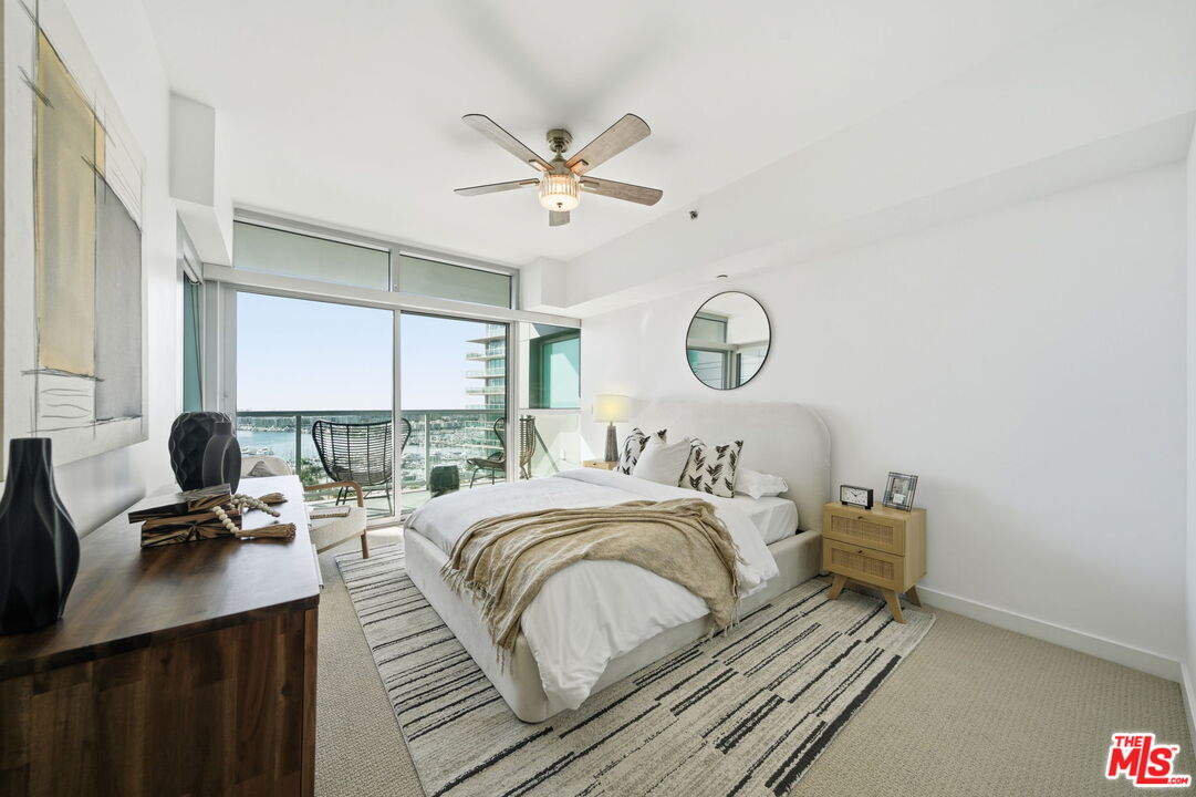 13650 Marina Pointe Drive, Unit 1603 Marina del Rey, CA 90292 - Photo 23 of 75 a bedroom with a bed window and a table