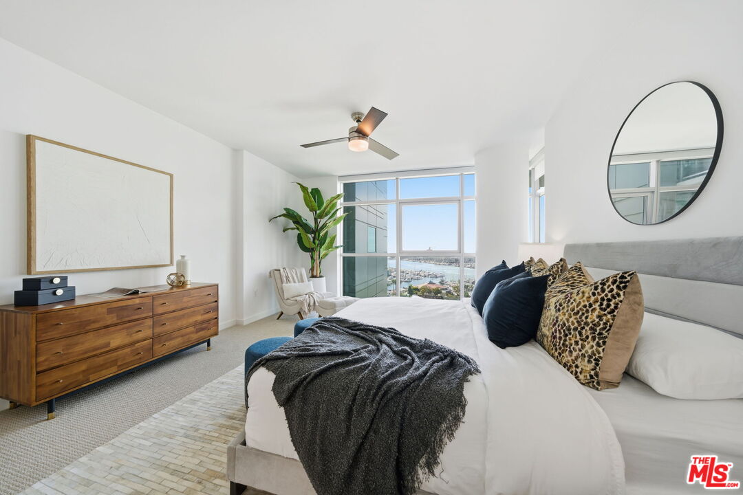 13650 Marina Pointe Drive, Unit 1603 Marina del Rey, CA 90292 - Photo 30 of 75 a spacious bedroom with a bed a couch and dresser
