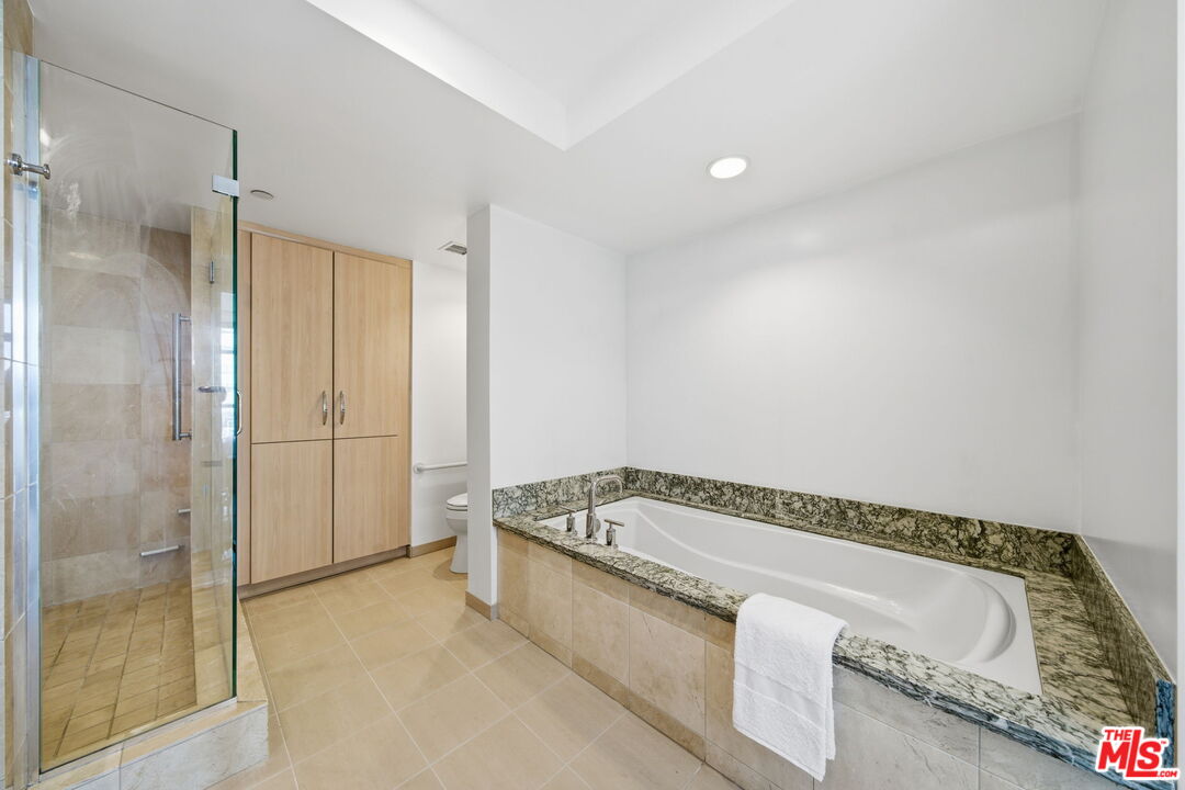 13650 Marina Pointe Drive, Unit 1603 Marina del Rey, CA 90292 - Photo 35 of 75 a spacious bathroom with a tub and shower