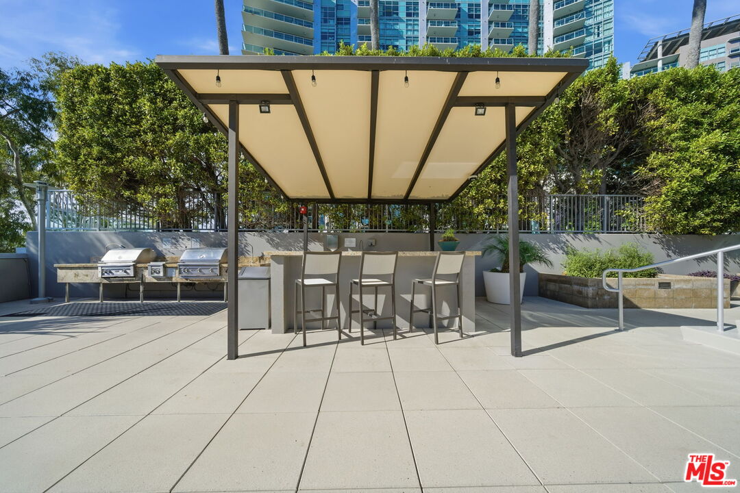 13650 Marina Pointe Drive, Unit 1603 Marina del Rey, CA 90292 - Photo 57 of 75 a view of a patio with table and chairs