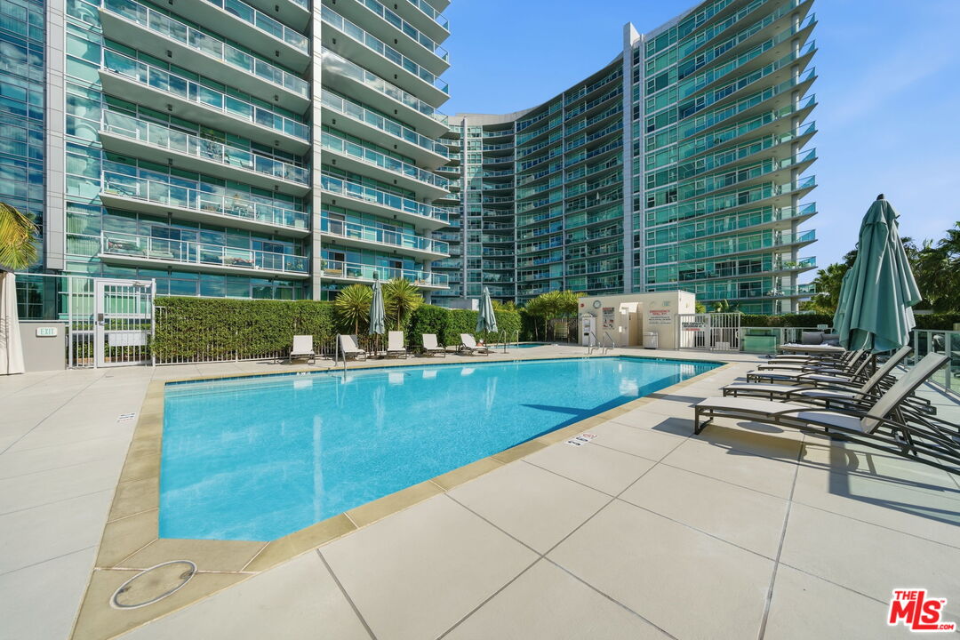 13650 Marina Pointe Drive, Unit 1603 Marina del Rey, CA 90292 - Photo 59 of 75 a view of a swimming pool with a lounge chairs
